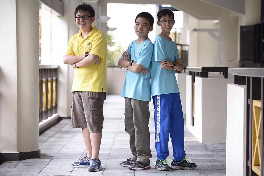 Xavier Lee, 13, Tan Han Yong and Lim Jing Xiang , both 12, who are under the Chinese Development Assistance Council's (CDAC) Project Excellence programme pictured after the awards ceremony for doing well in their exams on 27 Dec, 2014. The CDAC will 