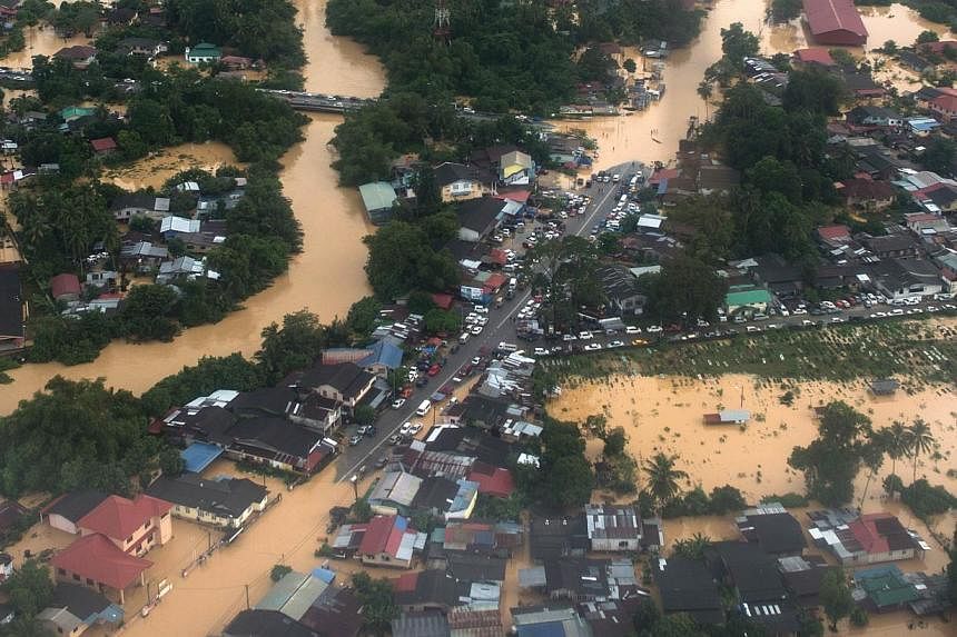 This aerial view shows houses submerged in floodwaters in Pengkalan Chepa, near Kota Bharu on Dec 27, 2014. -- PHOTO: AFP
