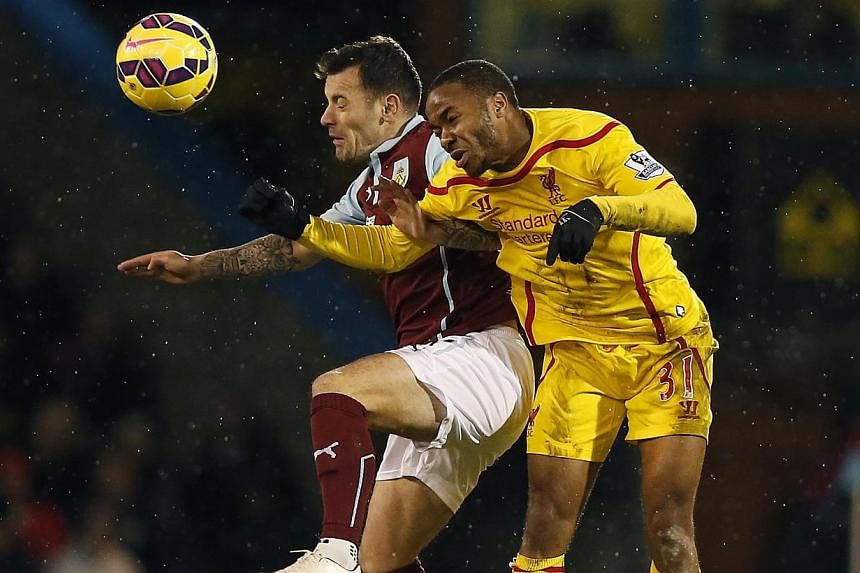 Burnley's Ross Wallace (left) is challenged by Liverpool's Raheem Sterling during their English Premier League soccer match at Turf Moor in Burnley, northern England Dec 26, 2014. -- PHOTO: REUTERS