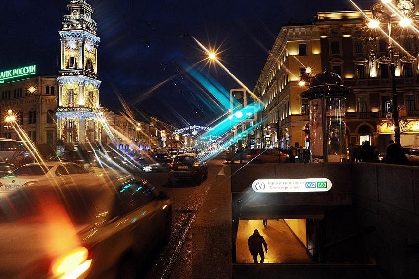 Nevsky Prospect is illuminated for Christmas and New Year celebrations in Saint Petersburg on Dec 23, 2014. The city has imposed rationing on metro tickets after people started panic-buying them ahead of a New Year price rise. -- PHOTO: AFP