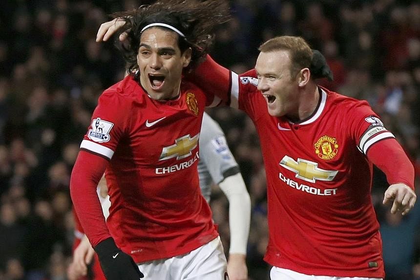 Manchester United's Wayne Rooney (right) celebrates after scoring a goal with team-mate Radamel Falcao during their English Premier League soccer match at Old Trafford in Manchester, northern England Dec 26, 2014. -- PHOTO: REUTERS
