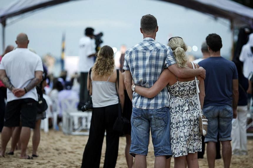 People attend a Swedish memorial service for victims of the 2004 tsunami at a beach in Khao Lak, Thailand on Dec 26, 2014. -- PHOTO: REUTERS