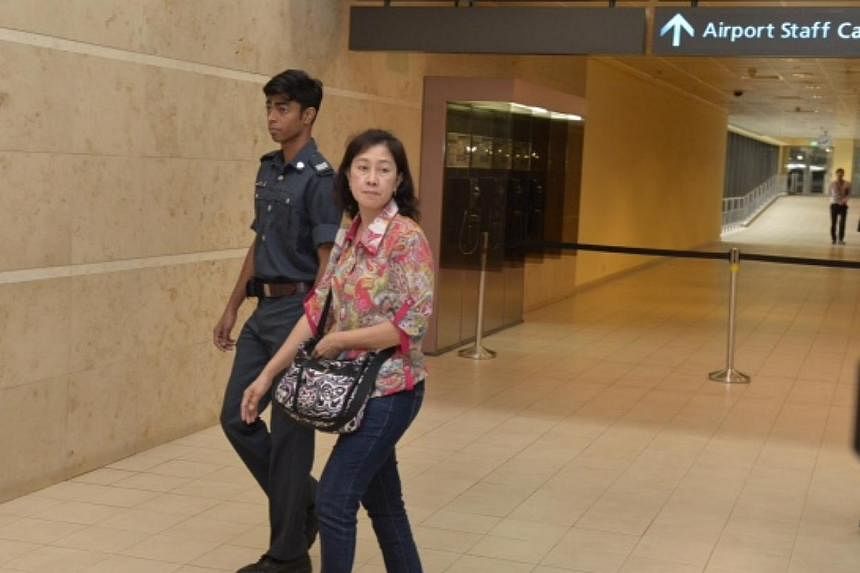 Unidentified next of kin entering the holding area at Changi Airport &nbsp;terminal 2 for relatives of the missing Air Asia flight on the 28 Dec 2014. -- ST PHOTO: DESMOND FOO