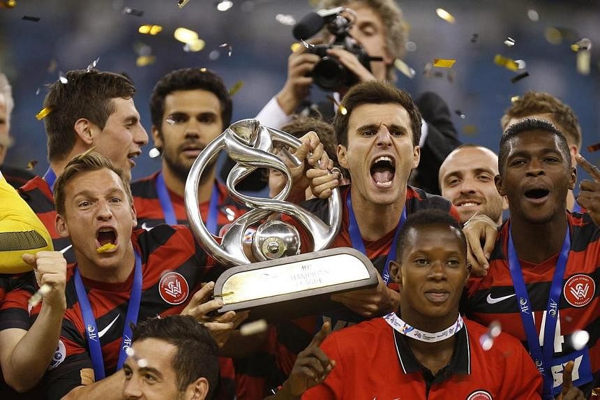 Australia's Western Sydney Wanderers hold the trophy as the celebrate winning their second-leg soccer match of the Asian Champions League final against Saudi Arabia's Al Hilal at King Fahd International Stadium in Riyadh on Nov 1, 2014. The Wanderers