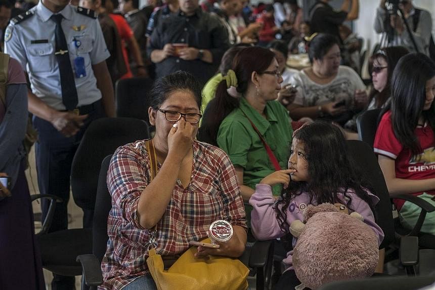 Family members of passengers of missing Malaysian air carrier AirAsia flight QZ8501 gather at Juanda international airport in Surabaya in East Java on Dec 28, 2014 hours after the news the flight went missing. -- PHOTO: AFP