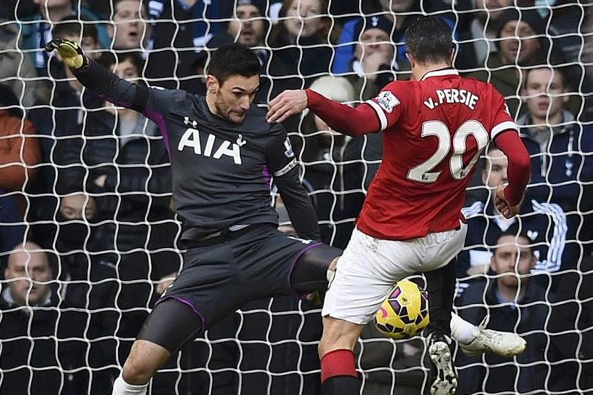 Manchester United's Robin van Persie (right) fails to score past Tottenham Hotspur's Hugo Lloris (left) during their English Premier League soccer match at White Hart Lane in London on Dec 28, 2014. -- PHOTO: REUTERS