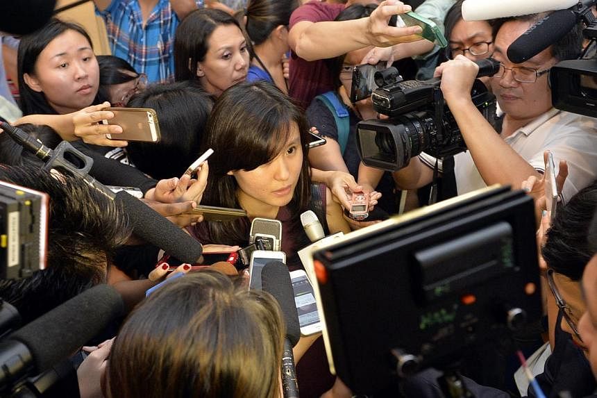 Ms Louise Sidharta, whose fiance was on AirAsia Indonesia flight QZ5801 which went missing, speaking to the media on Dec 28, 2014. Ms Sidharta had travelled on a separate flight and was supposed to join her fiance in Singapore. -- ST PHOTO: DESMOND F