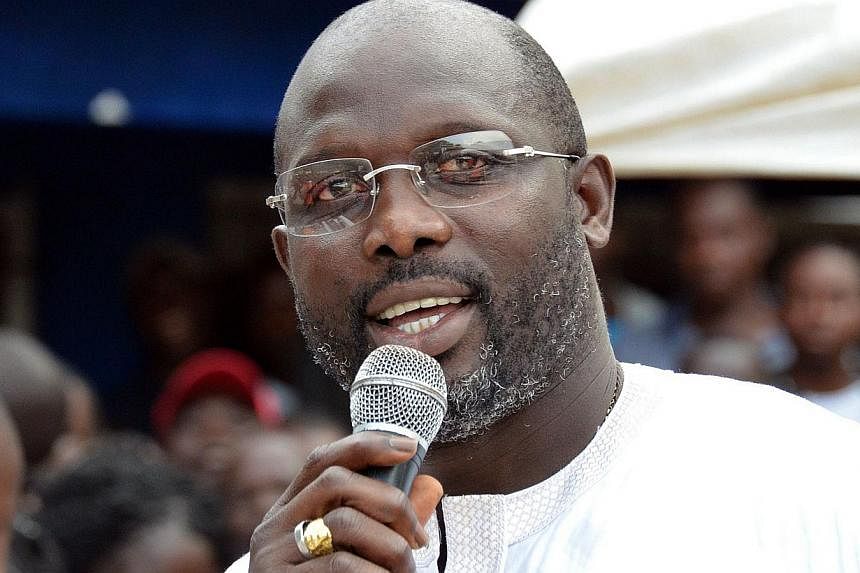 Former world football player of the year George Weah won a seat in Liberia's Senate to represent the capital, defeating the son of the president and boosting his political fortunes ahead of a presidential election in 2017. -- PHOTO: AFP
