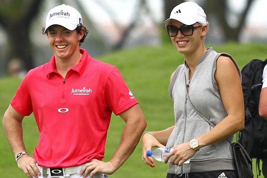 Golfer Rory McIlroy and then girlfriend, tennis player Caroline Wozniacki, at the Sentosa Golf Club in 2012 for the Barclays Singapore Open. -- PHOTO: NEW PAPER