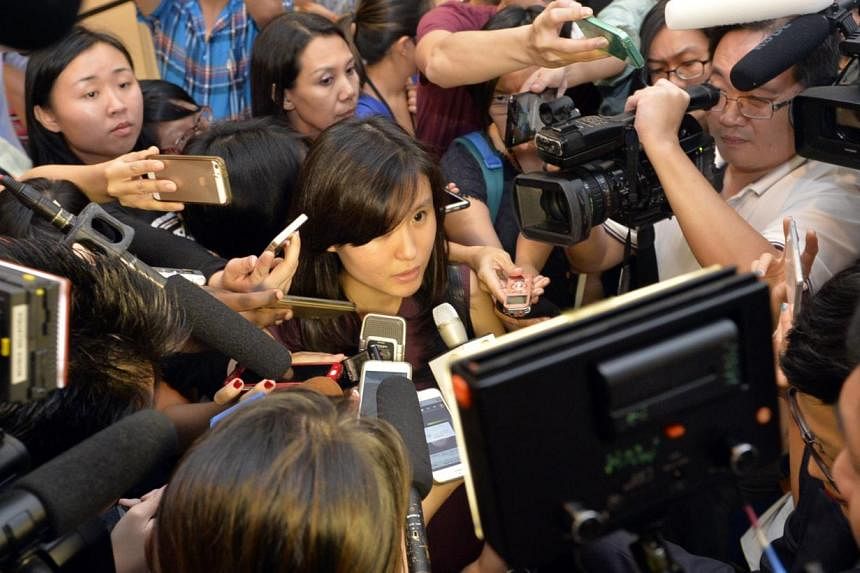 Louise Sidharta, 25, whose fiance Alain was travelling on AirAsia flight QZ8501 with his three brothers and parents, speaking to the media outside the holding room for relatives and next-of-kin at Changi Airport Terminal 2 on Dec 28, 2014. The flight