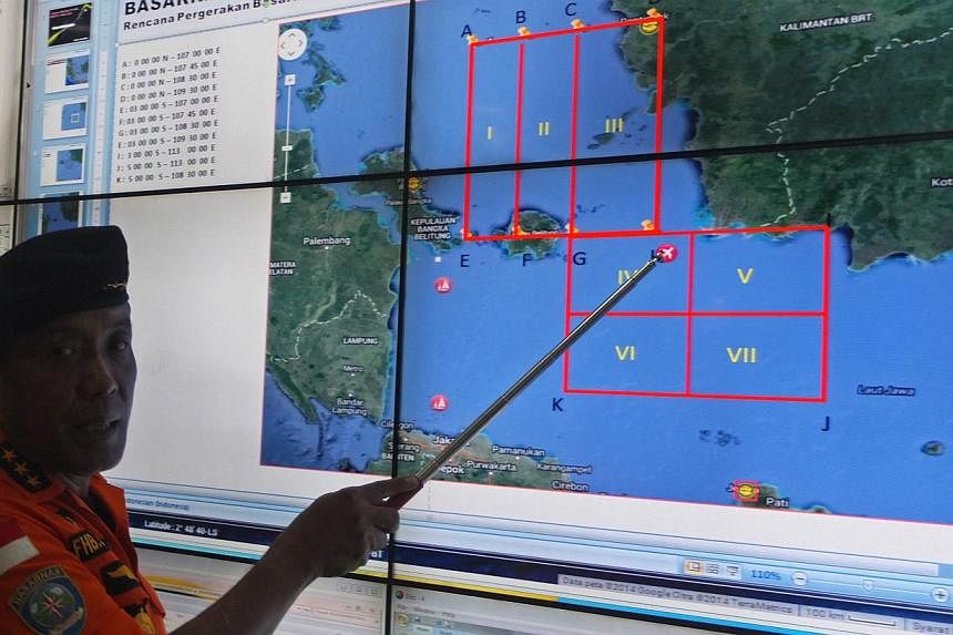 Basarnas (Indonesia's national search and rescue agency) chief F.H. Bambang Soelistyo points to the approximate location where the ill-fated AirAsia plane was last detected by radar on Sunday. -- ST PHOTO: WAHYUDI SOERIAATMADJA&nbsp;