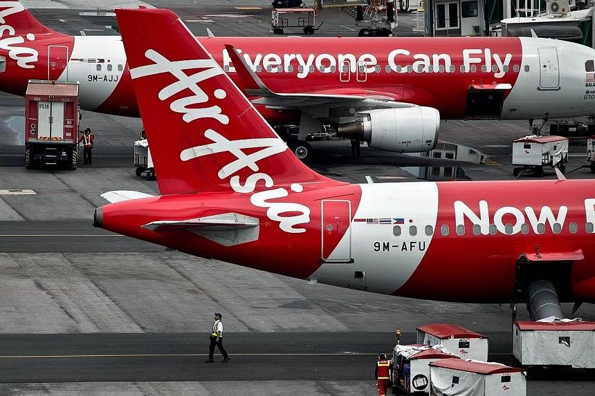 AirAsia Airbus A320 airplanes are parked on the tarmac at the low-cost carrier Kuala Lumpur International Airport 2 (KLIA2) in Sepang on Dec 28, 2014.&nbsp;A plane of AirAsia Zest with 178 passengers and six crew member was grounded in central Philip