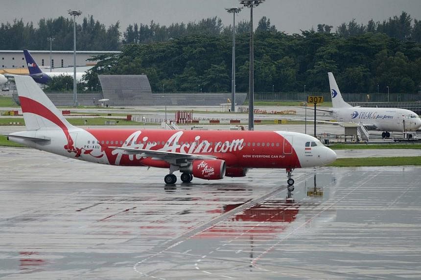Insurer Allianz SE could be exposed to claims of at least US$100 million linked to the AirAsia jet missing off the Indonesian coast with 162 people on board, which would be the third major airline accident it has been exposed to this year. -- PHOTO: 