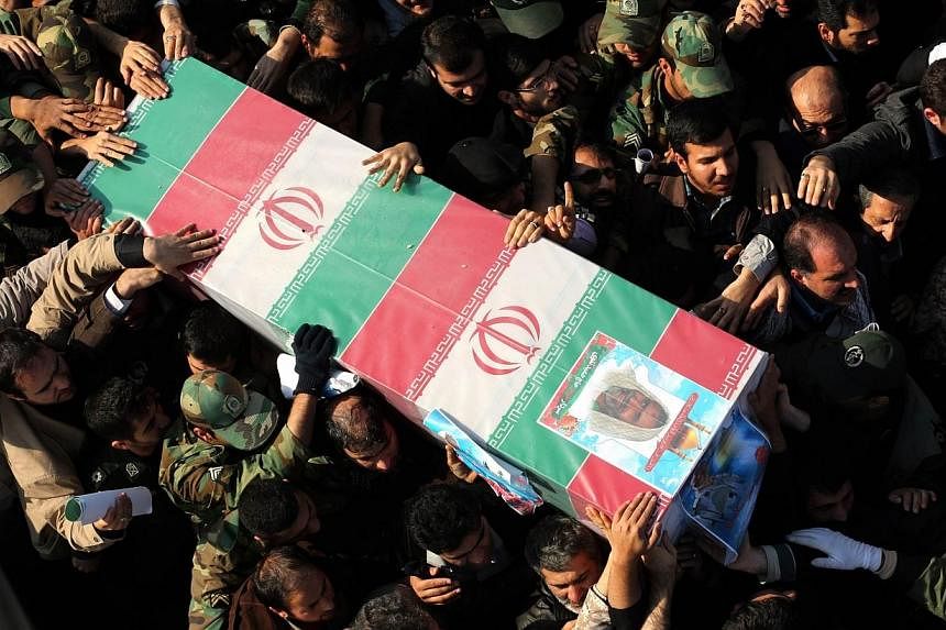 Iranians carry the coffin of Brigadier-General Hamid Taghavi, a commander of the Revolutionary Guards reportedly killed in the Iraqi city of Samarra, during his funeral in the capital Teheran on Dec 29, 2014.&nbsp;The Islamic State in Iraq and Syria 