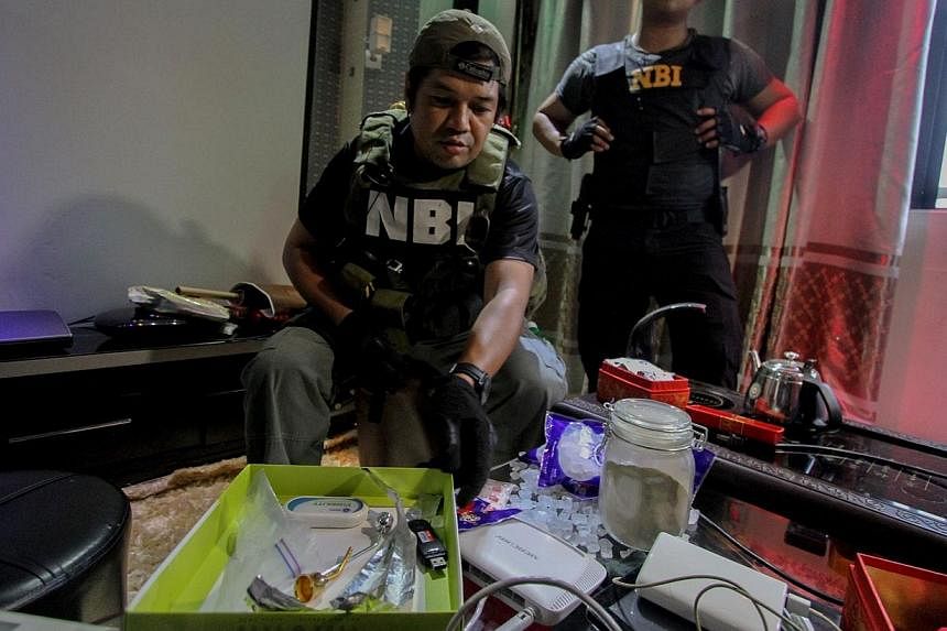 Convicts in the Philippines's main prison turned over an arsenal of firearms and improvised weapons including an Uzi machine-gun as part of a crackdown on privileged jail birds, the Justice Department said on Monday, Dec 29, 2014. -- PHOTO: AFP