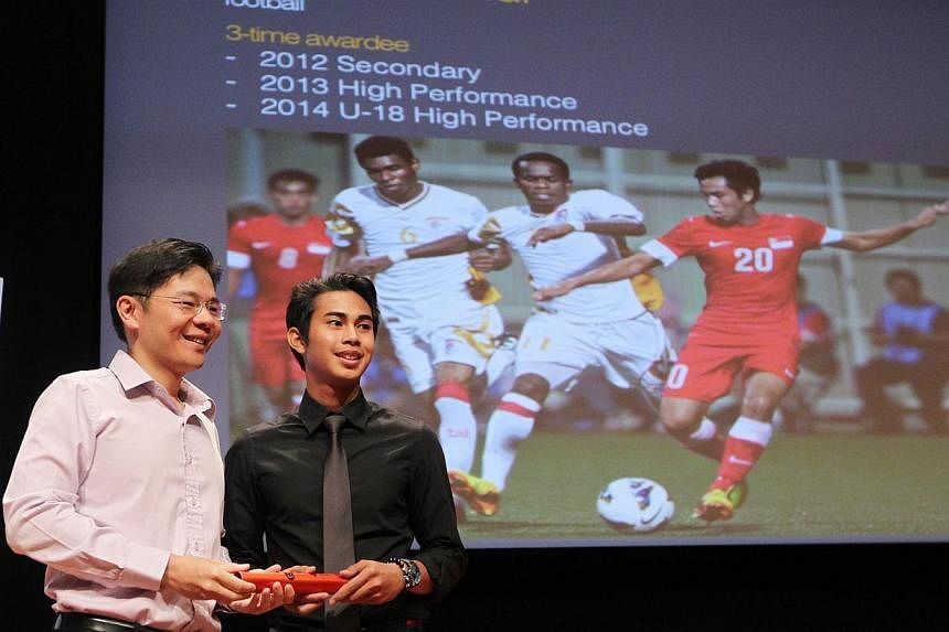 Minister for Culture, Community and Youth Lawrence Wong (left) posing with teenage national footballer Adam Swandi at Singapore Olympic Foundation-Peter Lim Scholarship Award ceremony held at the ITE College Central on July 5 2014.&nbsp;The scholarsh
