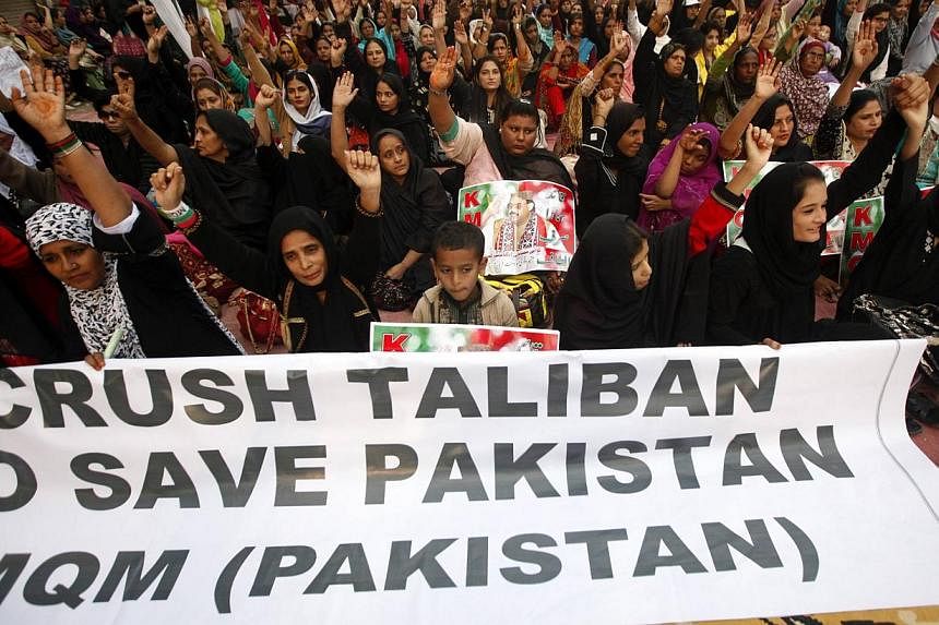 Protesters condemning the Taleban attack on the Army Public School in Peshawar, during a national solidarity rally in Karachi on Dec 19. The demonstration was led by the Muttahida Qaumi Movement (MQM), a political party whose supporters are firmly op