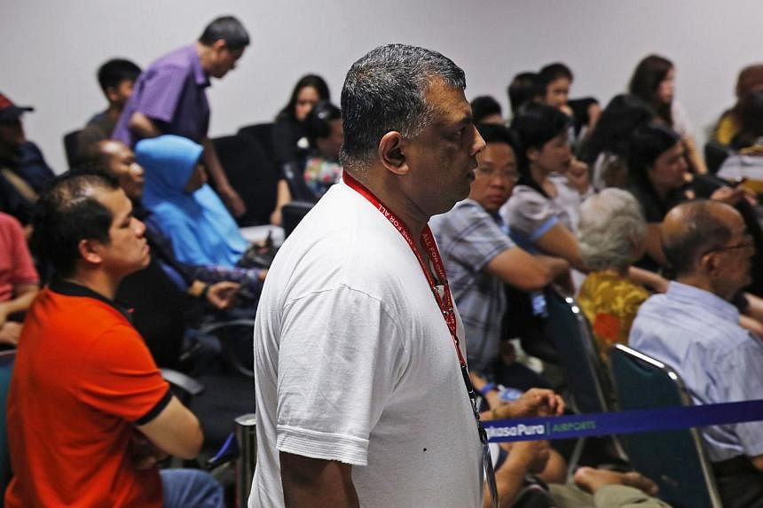 AirAsia CEO Tony Fernandes walks in front of family members of passengers onboard the missing AirAsia Flight QZ8501 at a news conference in Juanda International Airport, Surabaya on Dec 28, 2014.. -- PHOTO: REUTERS