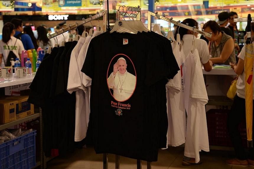 A stall run by a local trader for the Catholic church-funded broadcasting firm Radyo Veritas selling memorabilias marking Pope Francis' visit next month to the Philippines, Asia's largest Catholic nation. Business has been brisk, with black T-shirts 