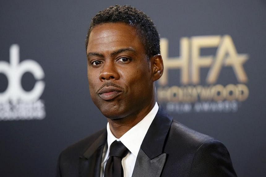 Actor Chris Rock poses backstage with his comedy film award for Top Five during the Hollywood Film Awards in Hollywood, California on November 14, 2014. -- REUTERS