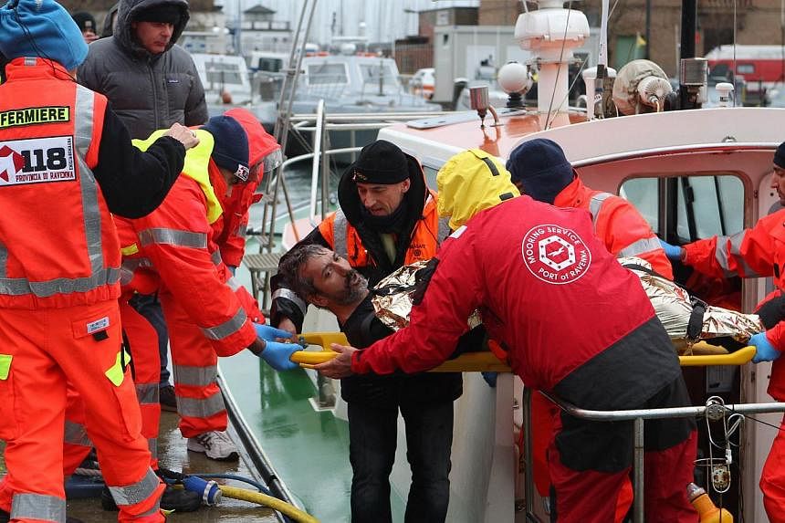 A rescued sailor is brought ashore in the harbor at Ravenna on Dec 28, 2014. -- PHOTO: AFP