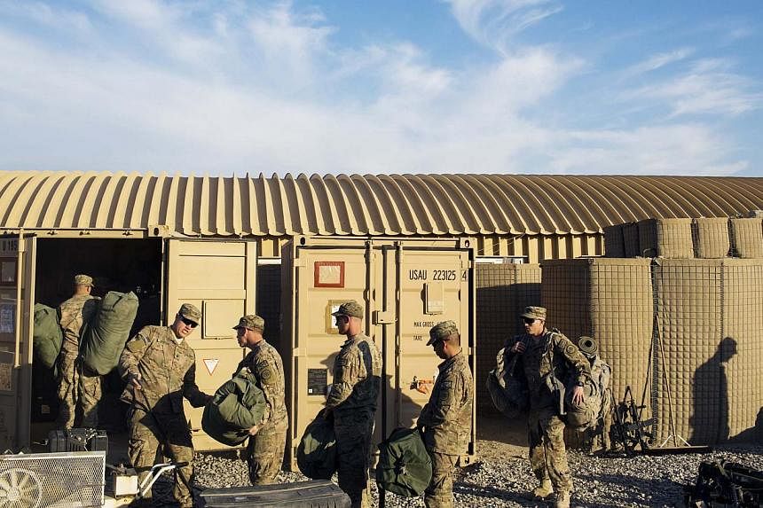 US soldiers from D Troop of the 3rd Cavalry Regiment load bags into a container in preparation for leaving Afghanistan at forward operating base Gamberi in the Laghman province on Dec 28, 2014. -- PHOTO: REUTERS
