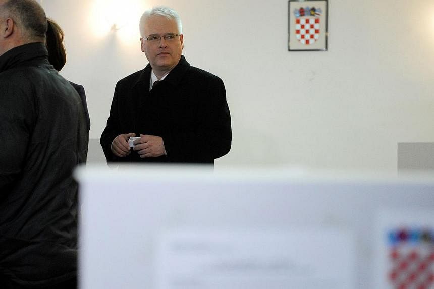 Croatian President Ivo Josipovic waiting to cast his vote at a polling station in Zagreb, Croatia, on Dec 28, 2014. -- PHOTO: AFP