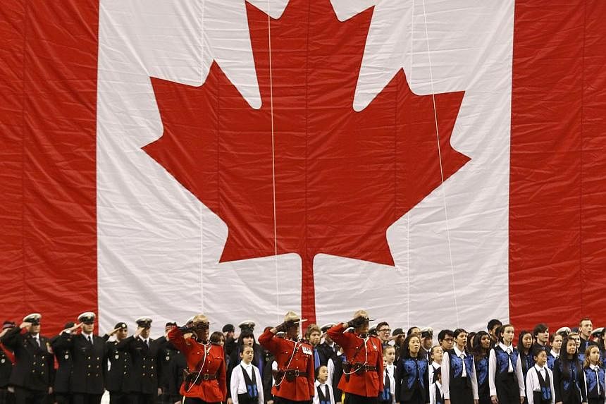 Members of the military and of the Royal Canadian Mounted Police joining children in ceremonies before the start of Canada's 102nd Grey Cup football championship in Vancouver, British Columbia, on Nov 30, 2014.&nbsp;Immigrant children raised in an en
