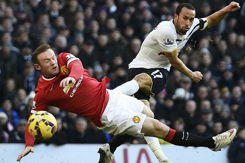 Manchester United's Wayne Rooney (left) challenges Tottenham Hotspur's Andros Townsend during their English Premier League soccer match at White Hart Lane in London Dec 28, 2014. -- PHOTO: REUTERS