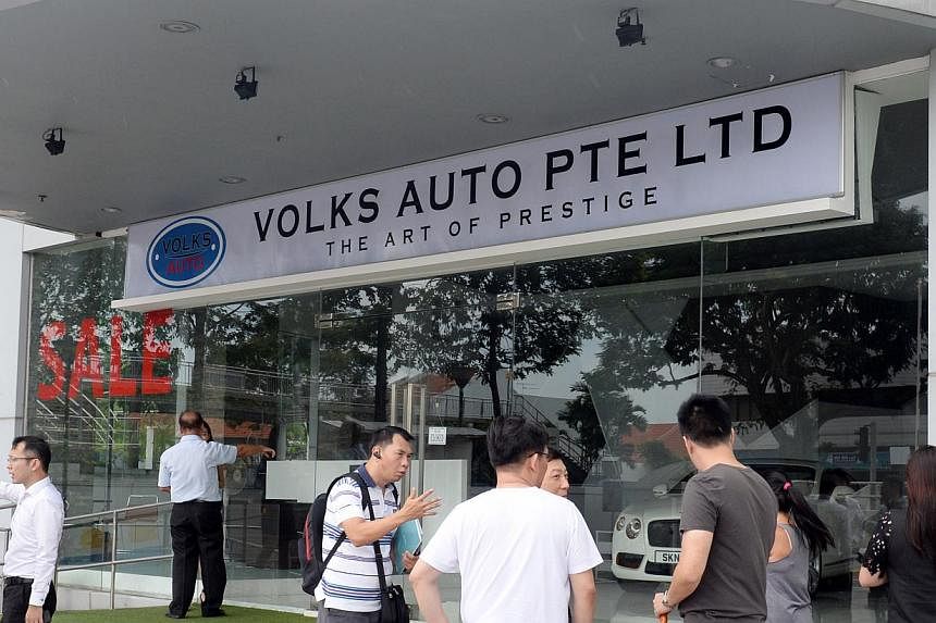 Mr K.K. Lo (above) suggests that consumers pay the $10,000 certificate of entitlement bidding deposit directly to the Land Transport Authority instead of through dealerships. Volks Auto (above, right) shut its doors more than two weeks ago after coll