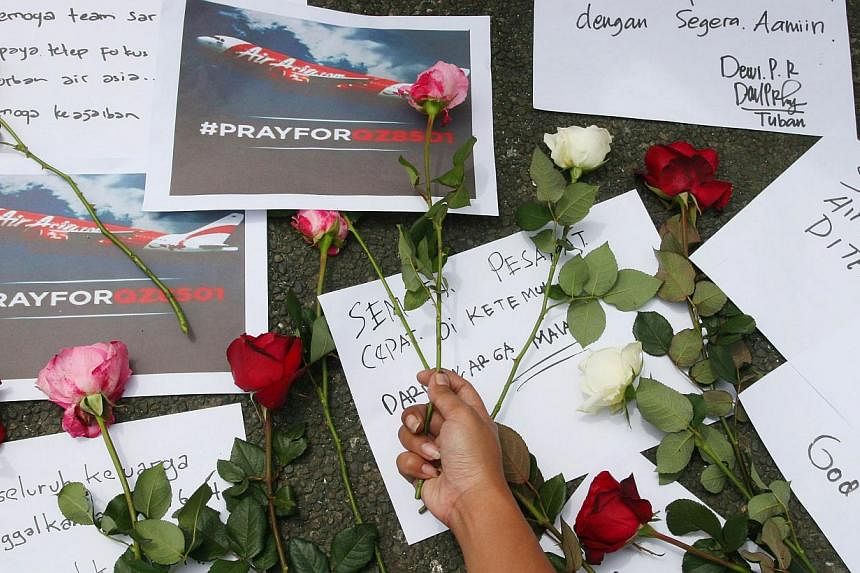 Indonesian people pray for passengers of the missing AirAsia flight QZ8501 in Malang, East Java on Dec 30, 2014. -- PHOTO: AFP