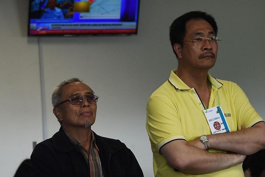 Family members of passengers on the missing plane react to news that floating debris was spotted on Dec 30, 2014. -- PHOTO: AFP