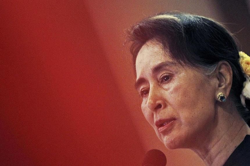 Myanmar's opposition leader Aung San Suu Kyi speaks at the National League for Democracy Party's central comity meeting at a restaurant in Yangon on Dec 13, 2014. - PHOTO: REUTERS