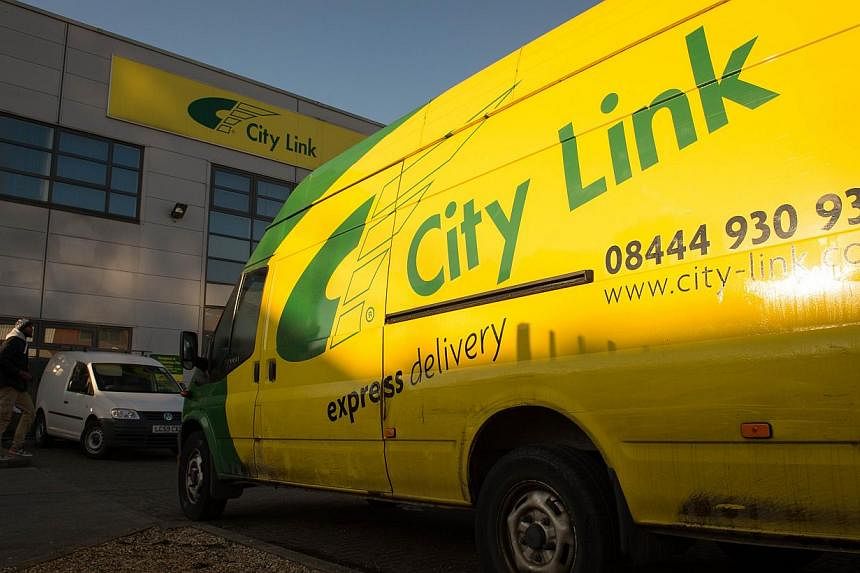 A City Link van parked outside a parcel delivery depot in south London on Dec 29, 2014. More than 2,000 workers at the British parcel delivery firm were told on Christmas Day that they would lose their jobs. -- PHOTO: AFP&nbsp;
