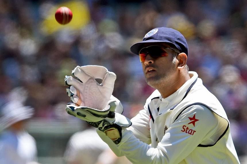 Indian wicketkeeper Mahendra Singh Dhoni catches the ball from the outfield during the second day of the third cricket Test match against Australia at the Melbourne Cricket Ground (MCG) in Melbourne on Dec 27, 2014. Dhoni&nbsp;announced his retiremen