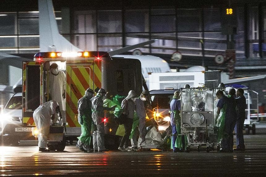 An Ebola patient is transferred onto a Hercules transport plane at Glasgow Airport in Scotland, to be sent to London, on Dec 30, 2014. A second health worker is being tested for Ebola in Scotland after returning from West Africa, a day after another 
