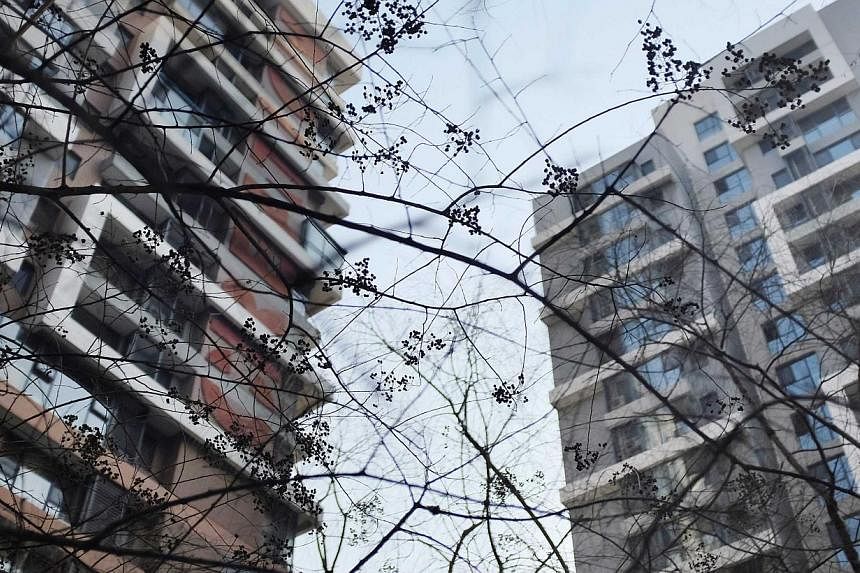 Apartment blocks in Beijing. A property developer in China reportedly hired a group of people with HIV to harass residents into leaving their homes. -- PHOTO: REUTERS