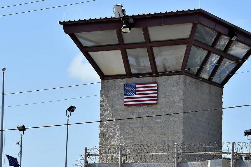 An April 8, 2014 photo shows the Camp 6 detention facility at the US Naval Station in Guantanamo Bay, Cuba. Three Yemenis and two Tunisians held for more than a decade at the military prison have been flown to Kazakhstan for resettlement. -- PHOTO: A