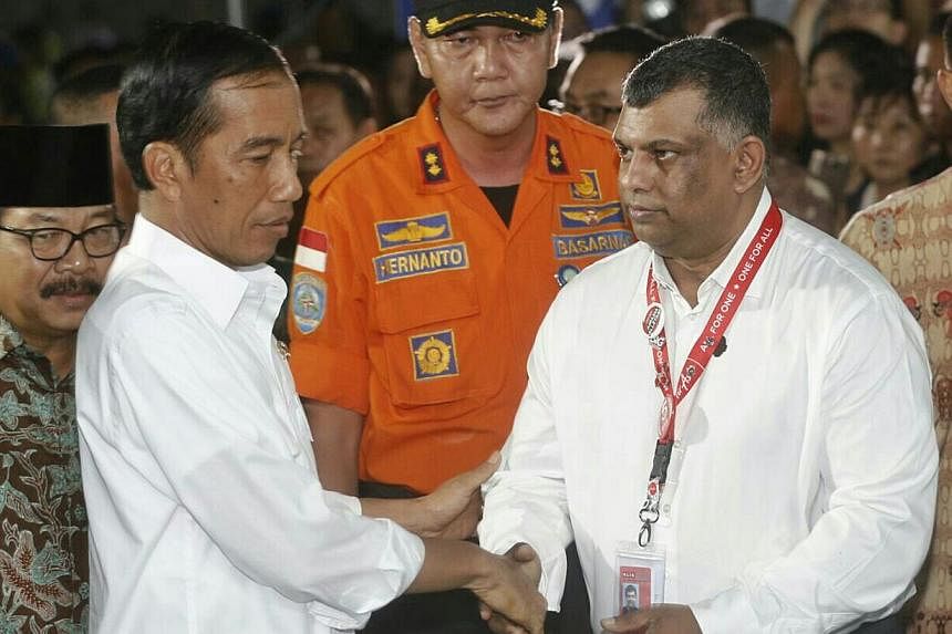 Mr Fernandes (right) greeting Indonesian President Joko Widodo when the latter arrived yesterday at the crisis centre at Juanda International Airport Terminal 2 in Surabaya to meet grieving family members.