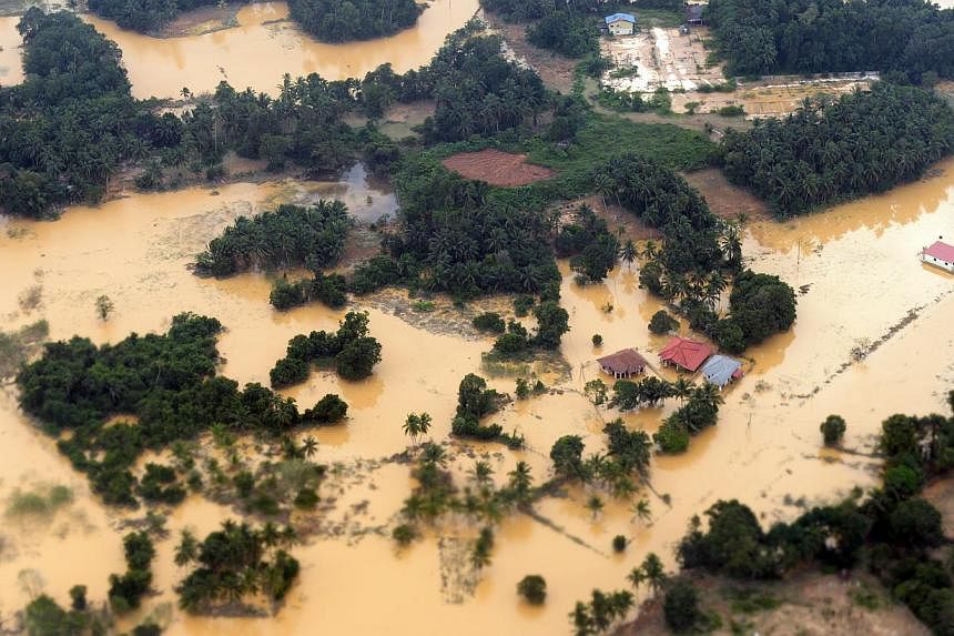 One of the badly hit areas in Kelantan, where rain has abated after heavy flooding in the past fortnight. Tens of thousands of people have been driven to shelters, where they remain amid fears of new floods. Many residents are not taking any chances 