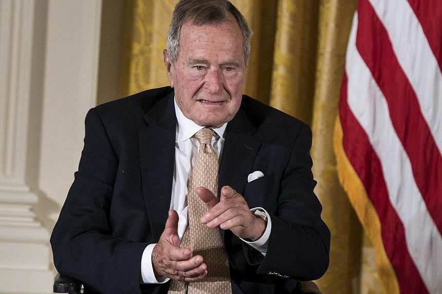 Former US President George H.W. Bush, 90, (above, in a 2013 file photo) was released from a Houston hospital on Tuesday after a week-long stay brought on by breathing difficulties, his spokesman said. -- PHOTO: AFP