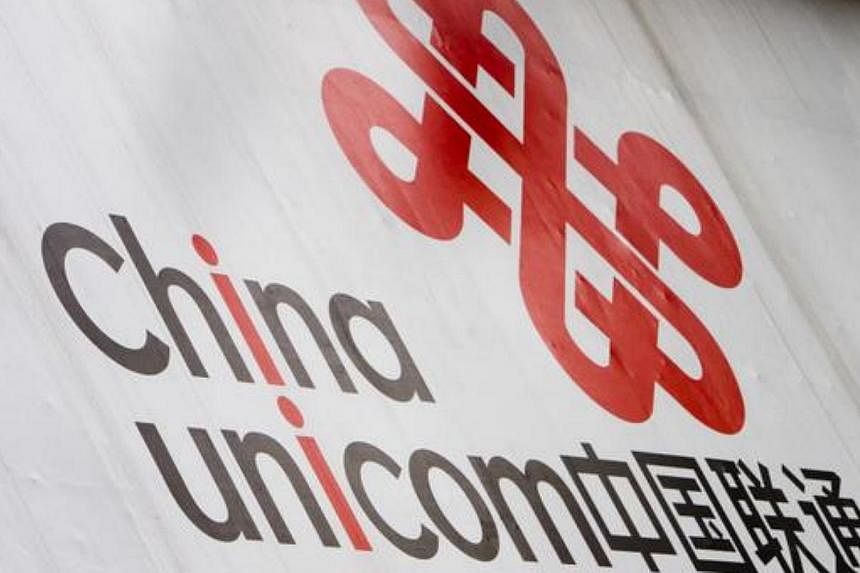 A sign for China Unicom marks the entrance to one of the companies's stores, in Guangzhou, China -- PHOTO: BLOOMBERG