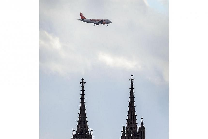 An easyJet plane flies above the cathedral at Basel. British low-cost carrier easyJet&nbsp;scrapped 138 French flights scheduled for New Year's Eve and New Year's Day due to a new round of strikes by cabin crew over profit sharing and staff rotas. --