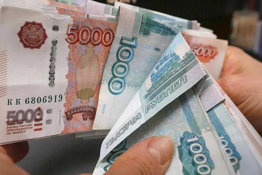 Even before the dramatic plunge in the rouble in the weeks running up to Christmas, the Russian central bank was predicting the economy could contract by up to 4.8 per cent next year if the price of oil fails to recover from five-year lows. -- PHOTO: