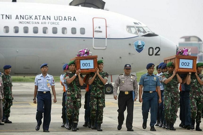 Two bodies from AirAsia flight QZ8501 arriving at Lanudal Airbase in Surabaya on Dec 31, 2014. -- ST PHOTO: KEVIN LIM
