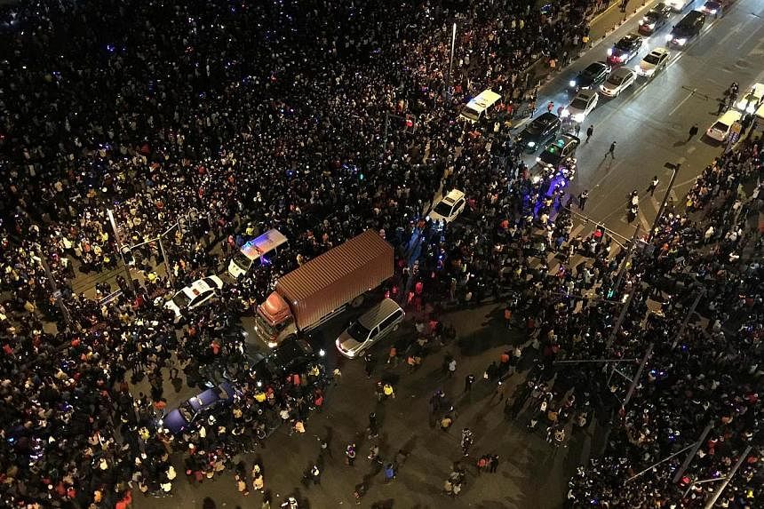 Emergency vehicles among the crowd after the stampede on Jan 1, 2015. -- PHOTO: AFP&nbsp;