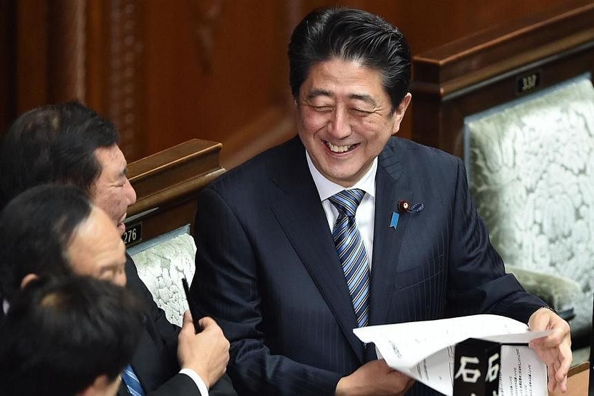 Mr Abe has embarked on a policy blitz - dubbed "Abenomics" to reinvigorate the economy, with a vast government spending and monetary easing programme. -- PHOTO: AFP