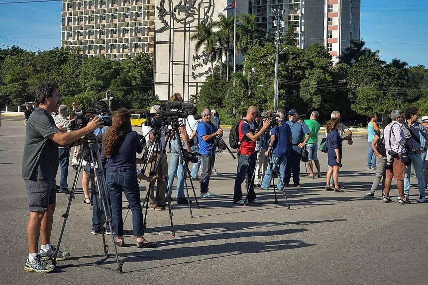 Journalists wait for Cuban performance artist Tania Bruguera at Revolution Square in Havana, on Dec 30, 2014. Bruguera had invited her compatriots to come and share their dreams for the island's future, but activity, promoted via social networks, did