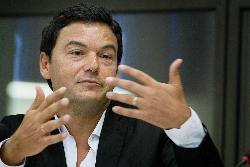 France's influential economist Thomas Piketty (above), author of Capital In The 21st Century, on Thursday refused to accept the country's highest award, the Legion d'honneur, to criticise the Socialist government in power. -- PHOTO: AFP