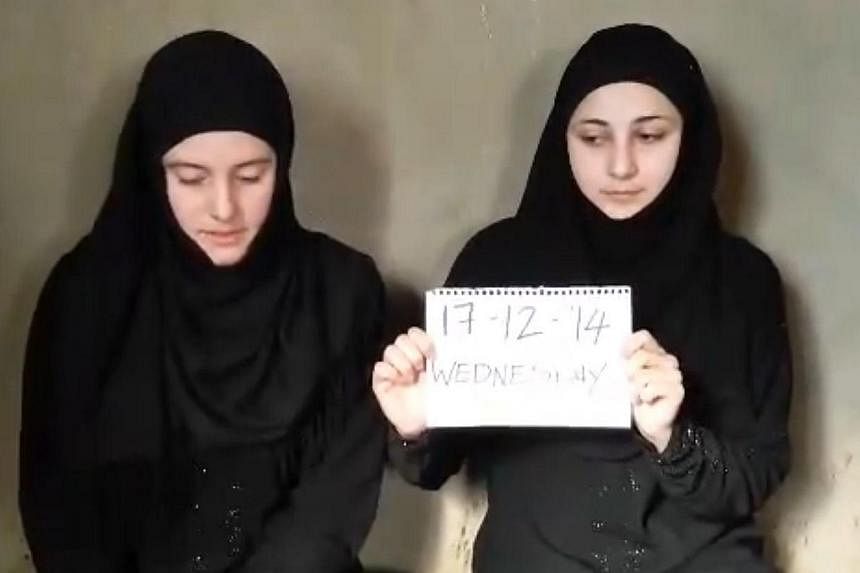 An image grab taken from a video allegedly broadcasted on Dec 17, 2014, and which appeared to have been posted online via an unofficial Islamic channel called "Islamic Sham" on YouTube on Dec 31, shows women identifying themselves as Italian national